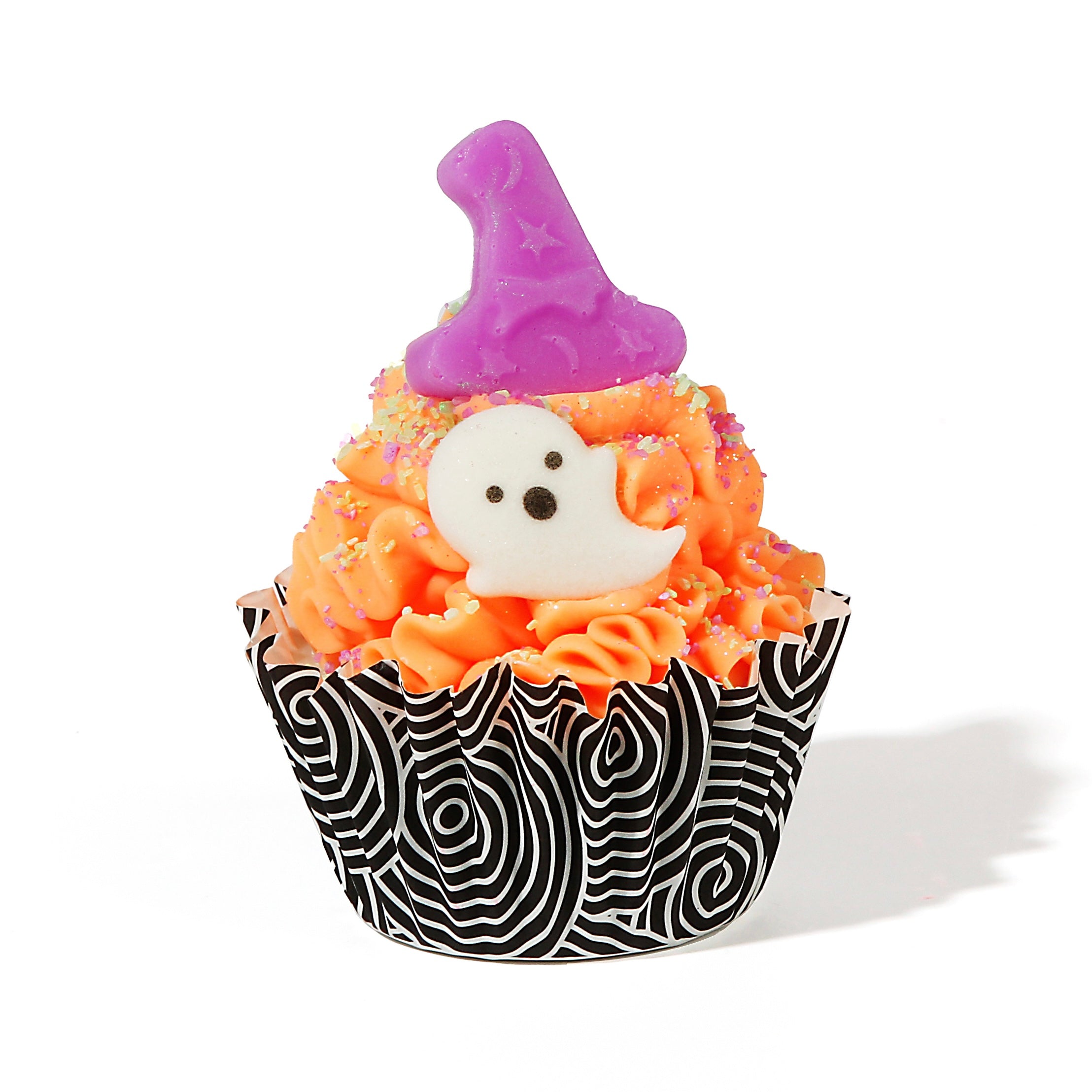 Realistic sized soap cupcake with a and black and white spiral patterned line. Bright orange soap frosting with a small ghost decoration and purple witch hat topper. 