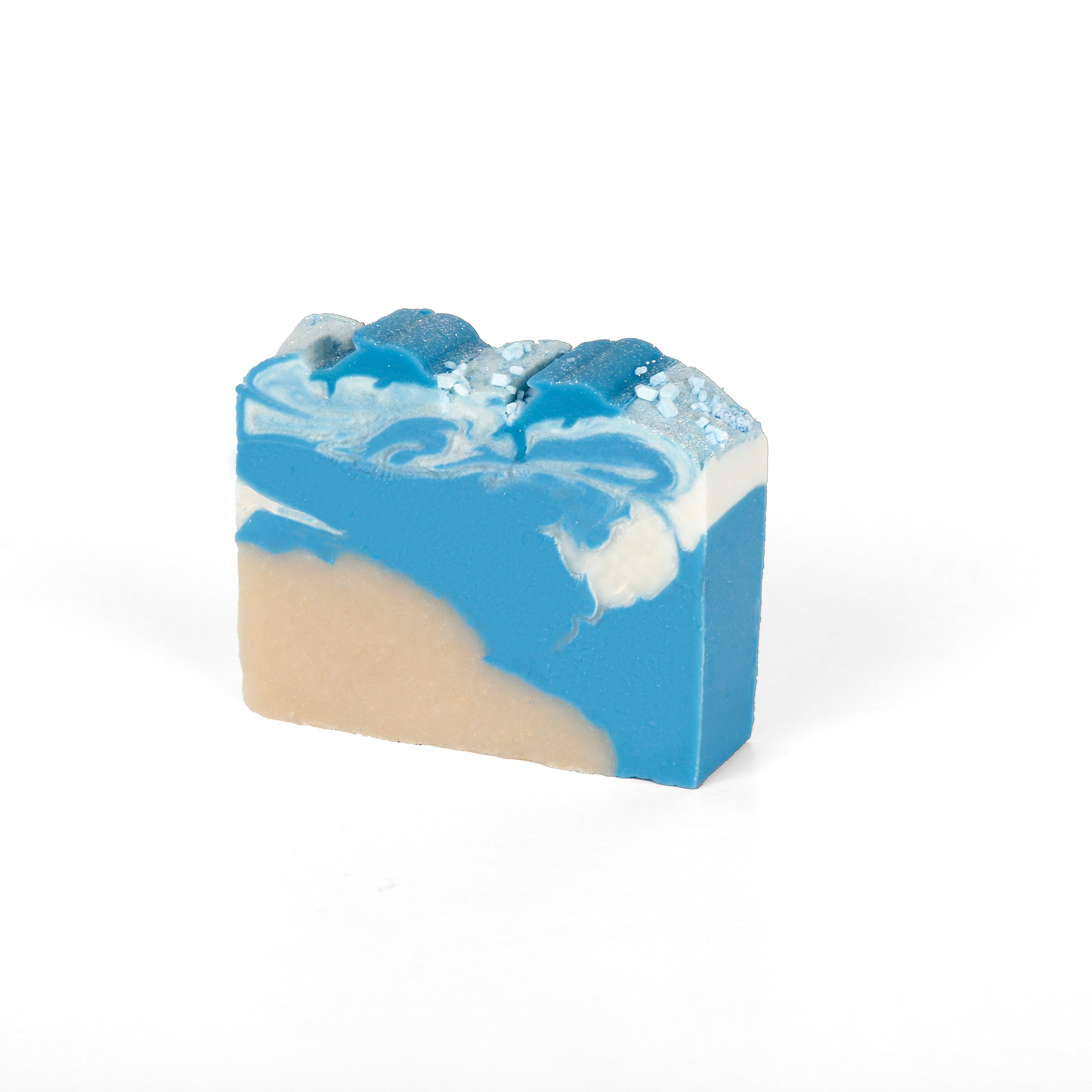 A blue and cream colored swirled bar soap. WIth a fluffy wave like texture on the top to portray ocean waves.