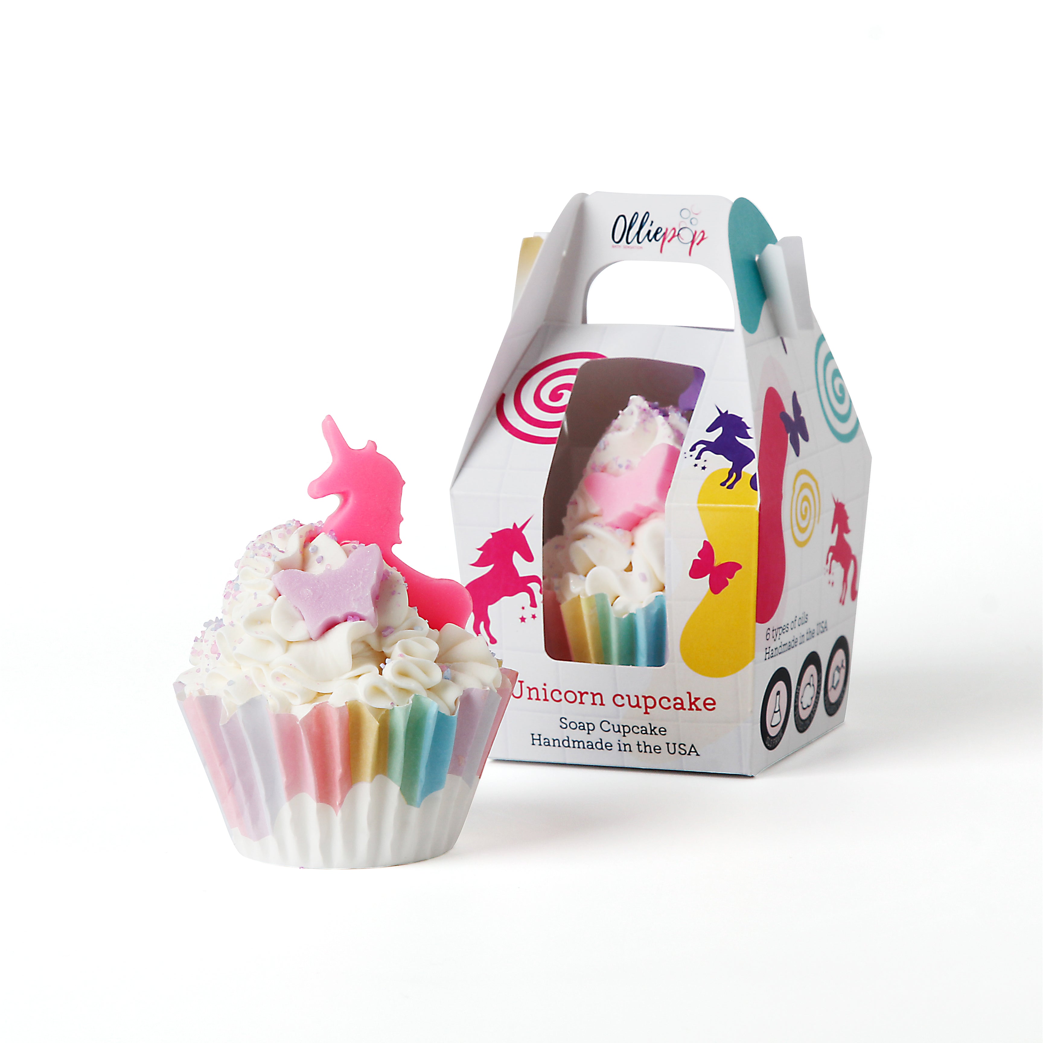 Unicorn themed soap shaped like a decadent cupcake. A rainbow cupcake liner with clouds. Inside is soap frosting with pastel sprinkles and a light purple butterfly cut out and a pink unicorn cut out, on top. packaged with our customized Olliepop packaging, perfect for gifts.